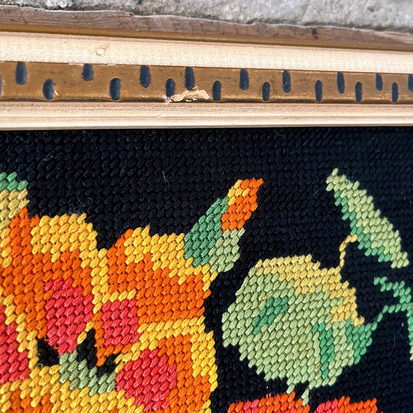 Bright floral needlepoint on black background