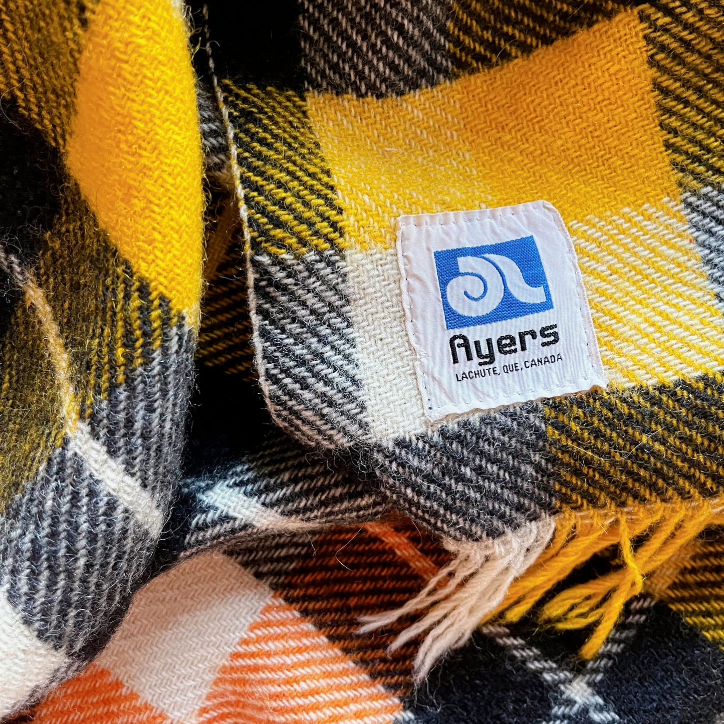 Ayers wool blanket in black, orange, yellow and white plaid